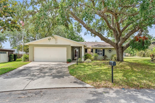 single story home featuring an attached garage, driveway, and a front yard