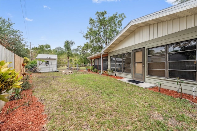 view of yard featuring a storage shed and an outdoor structure