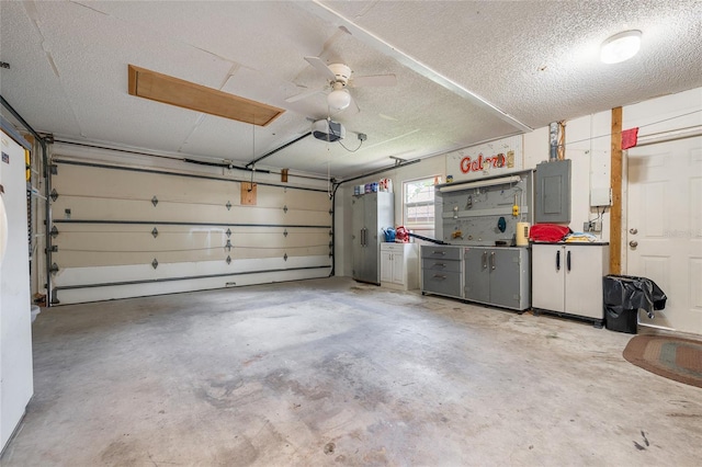 garage with a garage door opener and electric panel