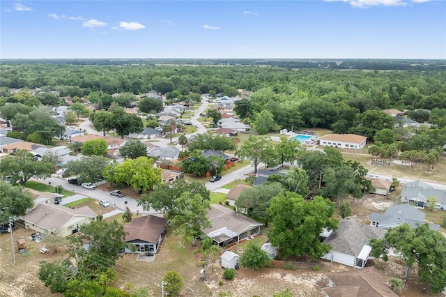aerial perspective of suburban area featuring a heavily wooded area