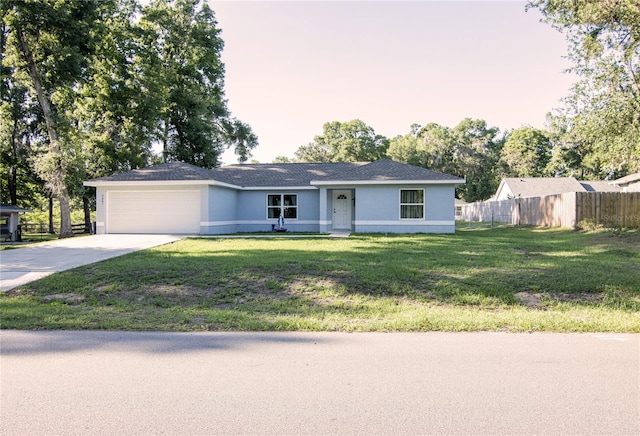 ranch-style home with an attached garage, driveway, and stucco siding
