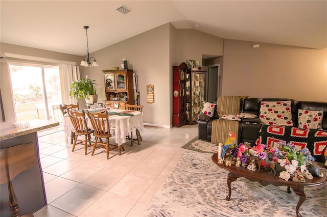 dining space featuring lofted ceiling, light tile patterned flooring, and baseboards