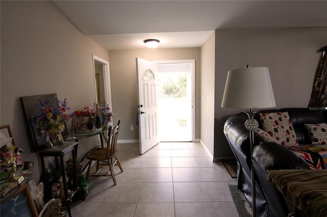 entryway with light tile patterned floors and baseboards