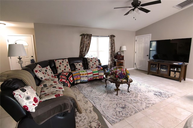 living area with ceiling fan, vaulted ceiling, light tile patterned flooring, and baseboards