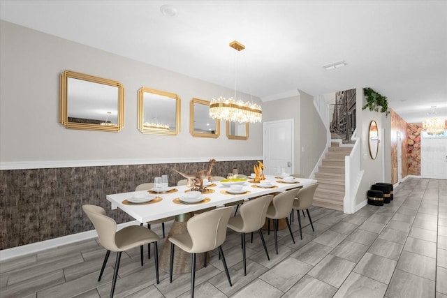 9020 Stinger Dr, Davenport, FL 33896 - dining area featuring a chandelier, stairway, wallpapered walls, wainscoting, and baseboards