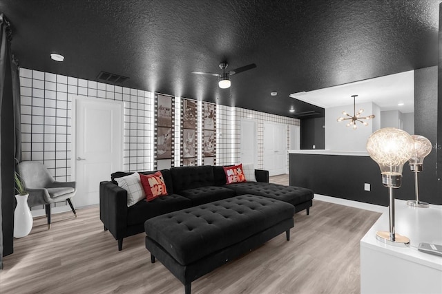9020 Stinger Dr, Davenport, FL 33896 - living room featuring wood finished floors, a chandelier, ceiling fan, and baseboards