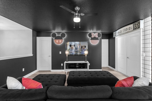 9020 Stinger Dr, Davenport, FL 33896 - cinema featuring wood finished floors, baseboards, and ceiling fan