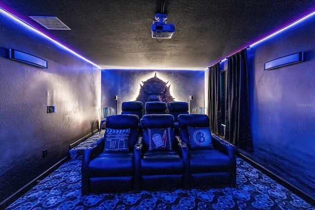 9020 Stinger Dr, Davenport, FL 33896 - carpeted home theater featuring a textured wall, a textured ceiling, and baseboards