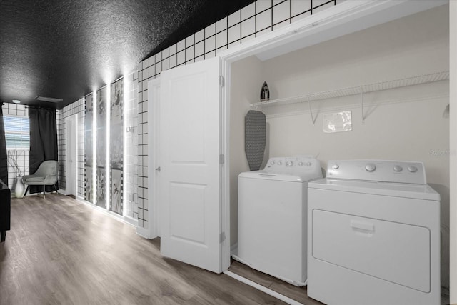 9020 Stinger Dr, Davenport, FL 33896 - clothes washing area with washing machine and clothes dryer and wood finished floors