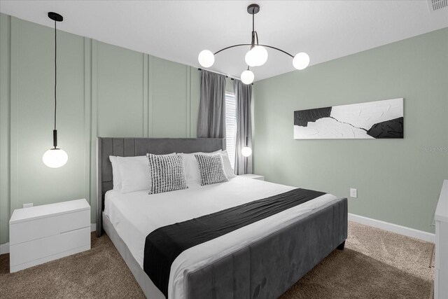 9020 Stinger Dr, Davenport, FL 33896 - bedroom with carpet, a chandelier, and baseboards