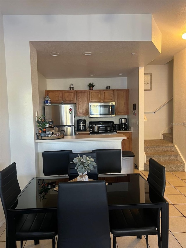2203 San Vittorino Cir Unit 103, Kissimmee, FL 34741 - dining room featuring light tile patterned floors, stairs, and recessed lighting