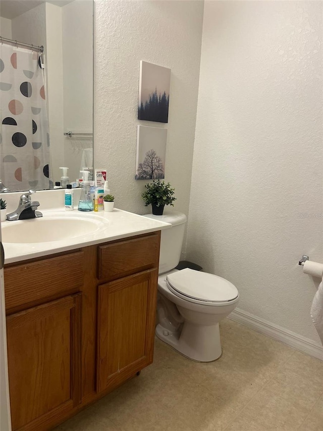 2203 San Vittorino Cir Unit 103, Kissimmee, FL 34741 - full bathroom featuring vanity, toilet, tile patterned floors, a textured wall, and a shower with curtain