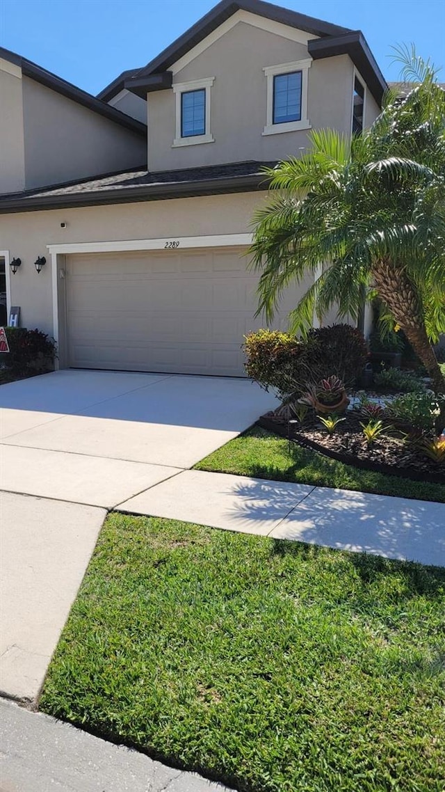 2289 Seven Oaks Dr, Saint Cloud, FL 34772 - traditional home with stucco siding, driveway, and an attached garage