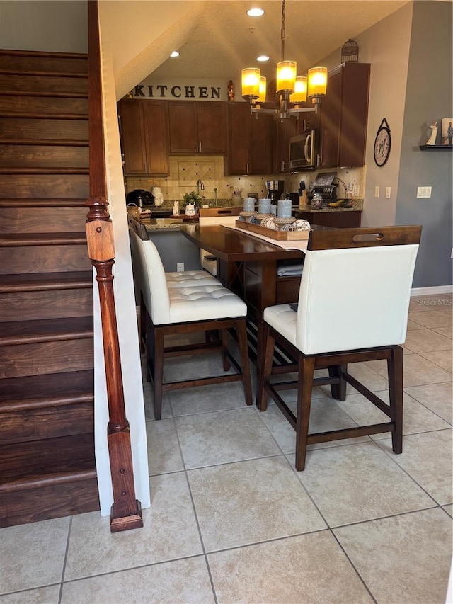 2289 Seven Oaks Dr, Saint Cloud, FL 34772 - dining area with a chandelier, light tile patterned flooring, recessed lighting, and baseboards