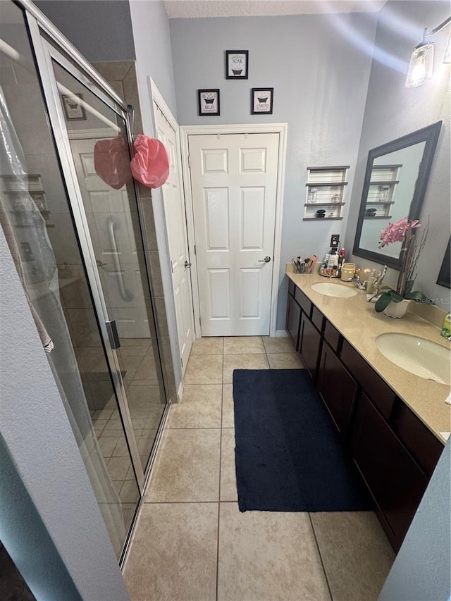 2289 Seven Oaks Dr, Saint Cloud, FL 34772 - bathroom with tile patterned flooring, a shower stall, and double vanity