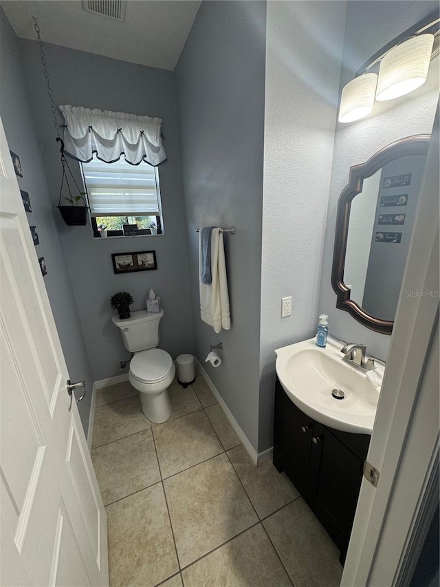 2289 Seven Oaks Dr, Saint Cloud, FL 34772 - half bathroom with vanity, tile patterned floors, toilet, and baseboards
