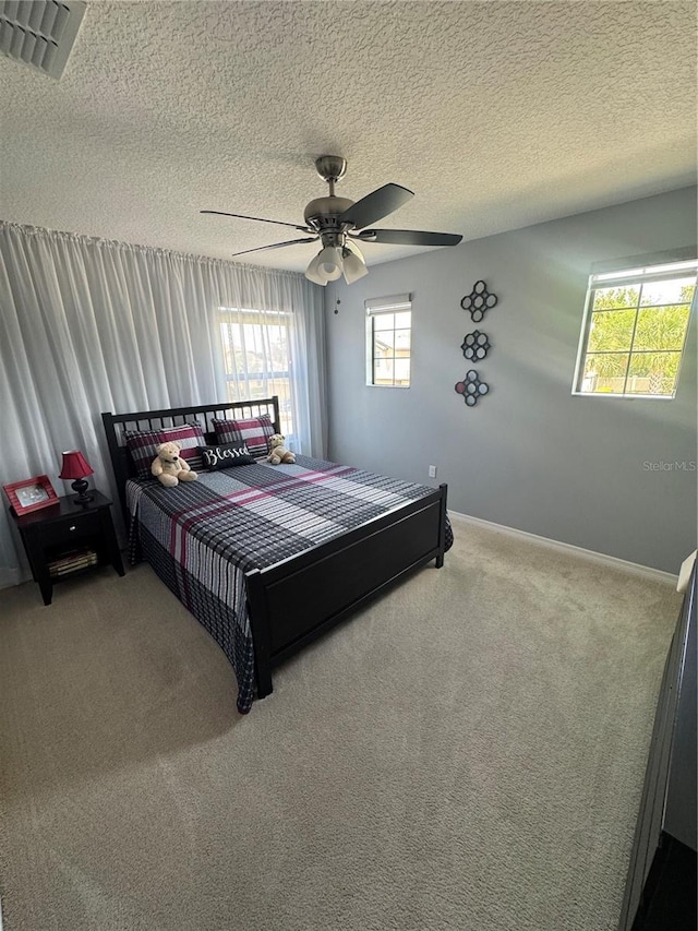 2289 Seven Oaks Dr, Saint Cloud, FL 34772 - carpeted bedroom featuring a textured ceiling, ceiling fan, and baseboards