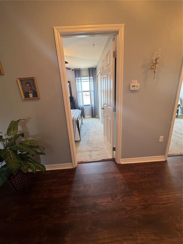 2289 Seven Oaks Dr, Saint Cloud, FL 34772 - hallway featuring baseboards and wood finished floors