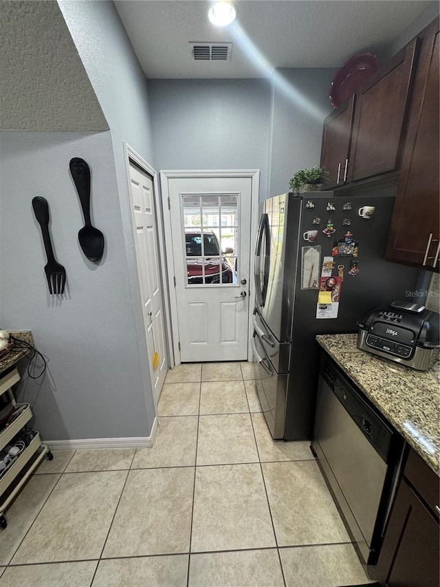 2289 Seven Oaks Dr, Saint Cloud, FL 34772 - laundry area with light tile patterned floors