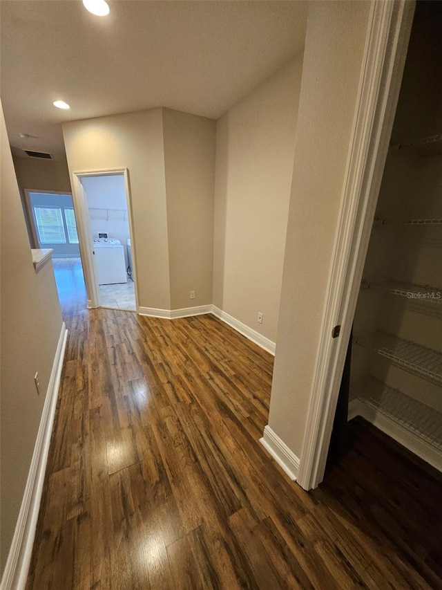 hall with washer / clothes dryer, dark wood finished floors, baseboards, and recessed lighting