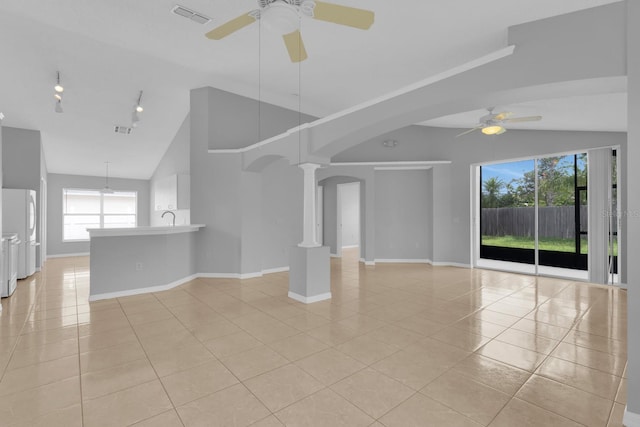 664 Eagle Pointe S, Kissimmee, FL 34746 - unfurnished living room featuring ceiling fan, light tile patterned flooring, track lighting, and lofted ceiling
