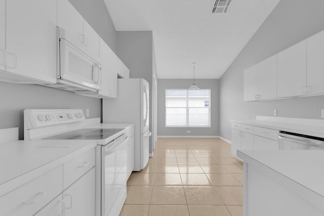 664 Eagle Pointe S, Kissimmee, FL 34746 - kitchen with white appliances, light countertops, white cabinetry, light tile patterned flooring, and baseboards
