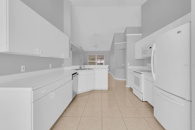 664 Eagle Pointe S, Kissimmee, FL 34746 - kitchen featuring white appliances, a peninsula, a sink, light countertops, and white cabinetry