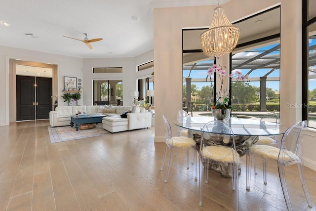 dining room with a chandelier, wood finished floors, and baseboards