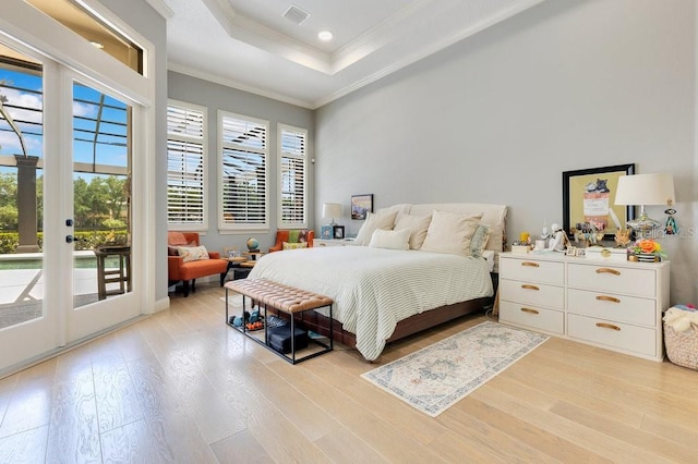 bedroom with access to exterior, crown molding, light wood-style flooring, a tray ceiling, and french doors