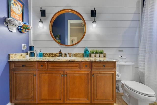 full bath featuring vanity and toilet