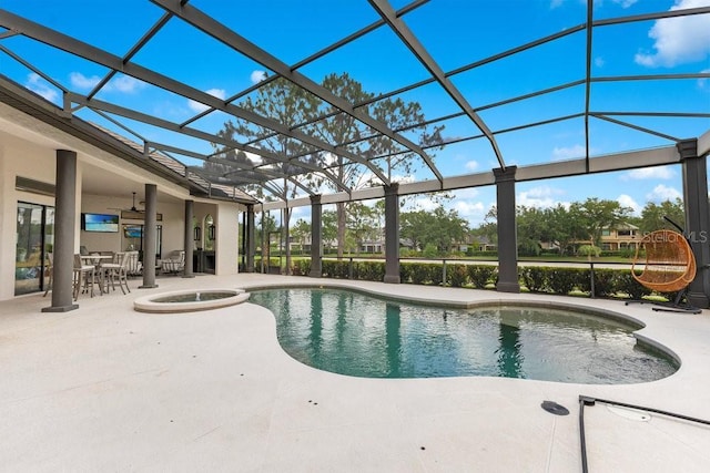 view of swimming pool with a patio, glass enclosure, a pool with connected hot tub, and outdoor dining area