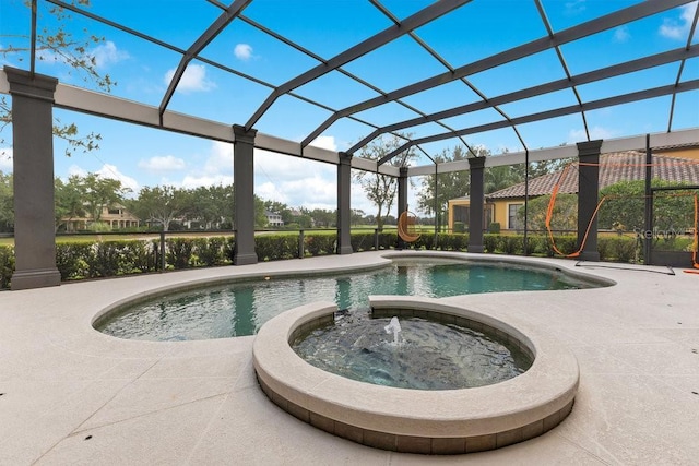 view of swimming pool with a pool with connected hot tub, a lanai, and a patio
