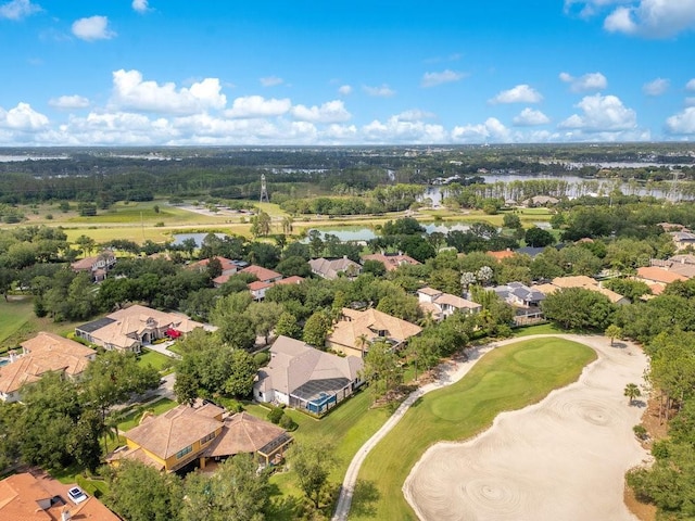 aerial perspective of suburban area featuring a nearby body of water, a tree filled landscape, and a local golf course