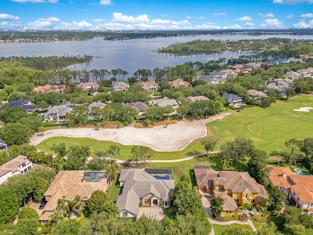 aerial overview of property's location with nearby suburban area, a nearby body of water, and a local golf course