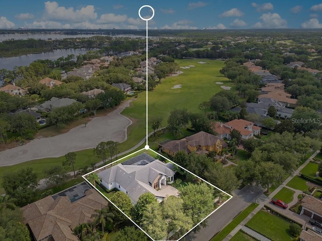 aerial view of residential area with a large body of water, property parcel outlined, and a golf club