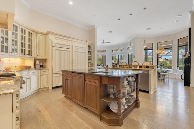 6761 Valhalla Way, Windermere, FL 34786 - kitchen with cream cabinetry, a center island with sink, light wood finished floors, recessed lighting, and stainless steel dishwasher