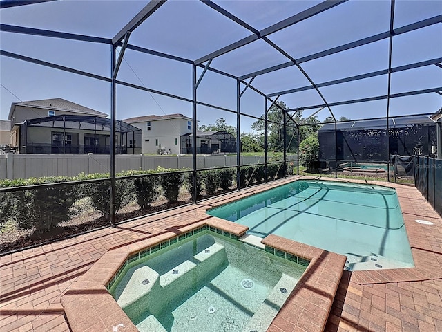 1614 Lima Ave, Kissimmee, FL 34747 - view of pool featuring a pool with connected hot tub, a patio, a residential view, glass enclosure, and a fenced backyard