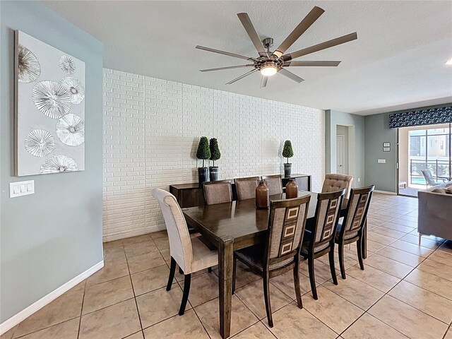 1614 Lima Ave, Kissimmee, FL 34747 - dining area with light tile patterned floors, ceiling fan, and baseboards