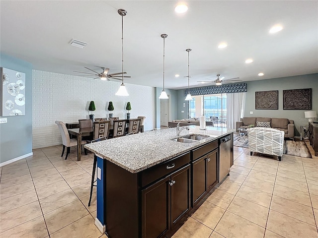 1614 Lima Ave, Kissimmee, FL 34747 - kitchen featuring a sink, a ceiling fan, open floor plan, dishwasher, and light tile patterned flooring