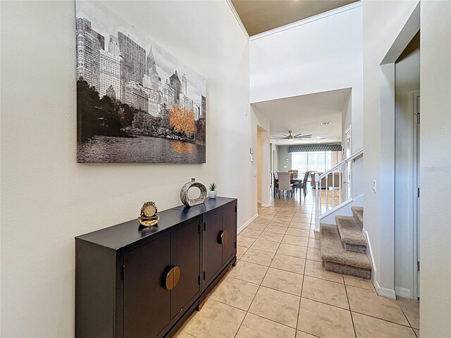 1614 Lima Ave, Kissimmee, FL 34747 - hall with light tile patterned floors, stairs, and baseboards