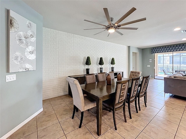 1614 Lima Ave, Kissimmee, FL 34747 - dining area with ceiling fan, light tile patterned floors, and baseboards