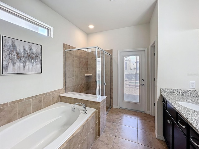 1614 Lima Ave, Kissimmee, FL 34747 - bathroom with a stall shower, a bath, vanity, and tile patterned floors