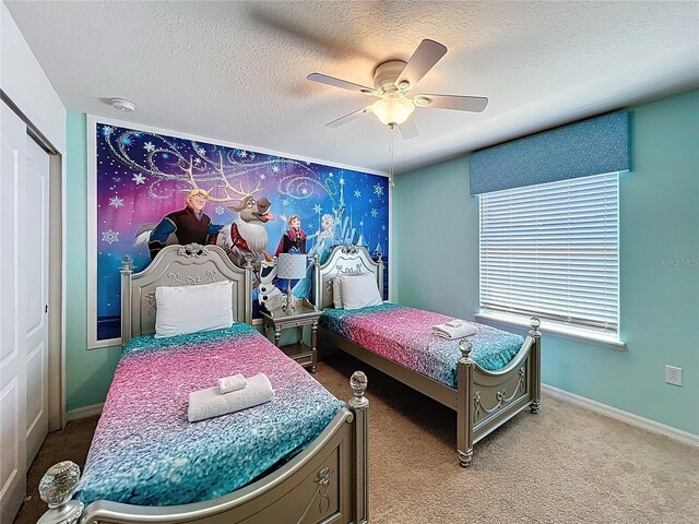 1614 Lima Ave, Kissimmee, FL 34747 - bedroom with a textured ceiling, carpet, a ceiling fan, and baseboards