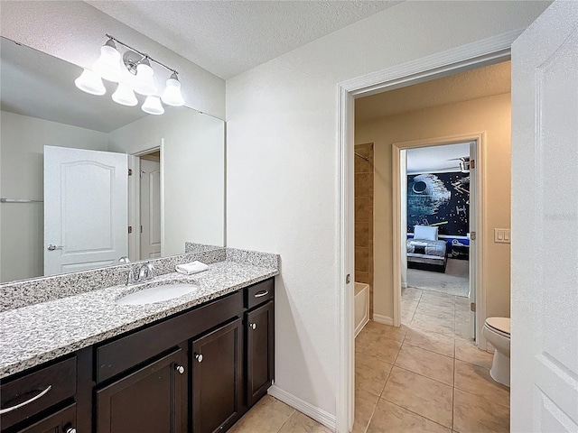 1614 Lima Ave, Kissimmee, FL 34747 - full bath with vanity, toilet, tile patterned flooring, shower / bath combination, and a textured ceiling