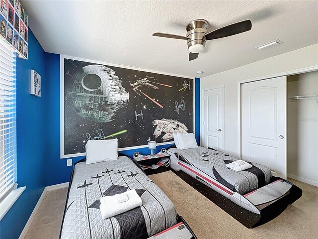 1614 Lima Ave, Kissimmee, FL 34747 - bedroom featuring carpet flooring, baseboards, a ceiling fan, and a textured ceiling