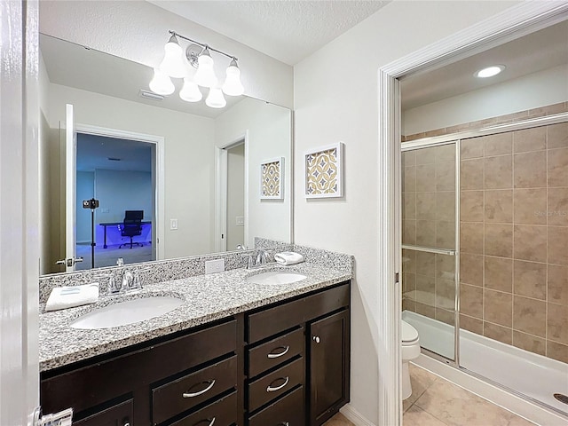 1614 Lima Ave, Kissimmee, FL 34747 - bathroom with tile patterned floors, a stall shower, toilet, and double vanity