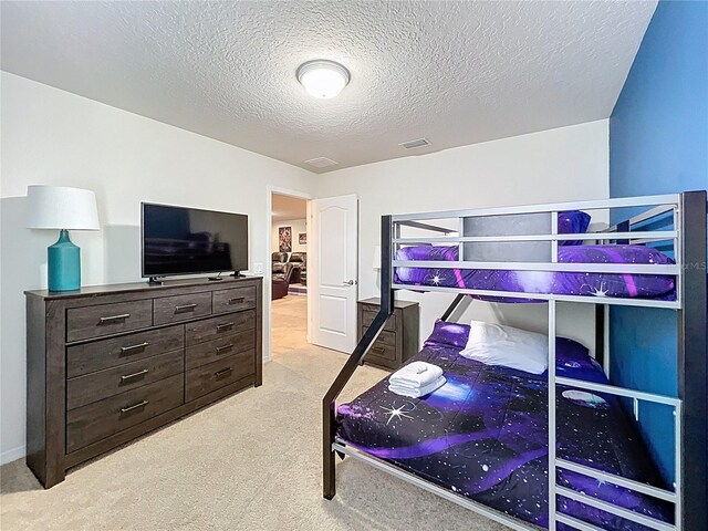 1614 Lima Ave, Kissimmee, FL 34747 - bedroom with light colored carpet and a textured ceiling