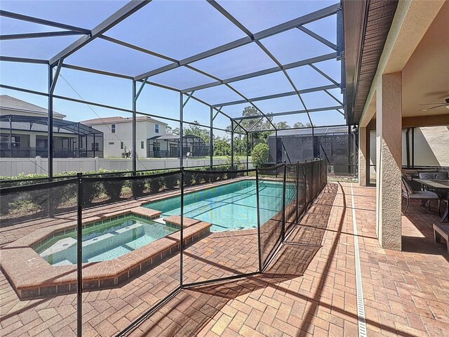 1614 Lima Ave, Kissimmee, FL 34747 - view of swimming pool with a patio area, a pool with connected hot tub, ceiling fan, and a residential view