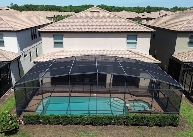 1614 Lima Ave, Kissimmee, FL 34747 - back of house featuring a tiled roof, a lanai, and a patio
