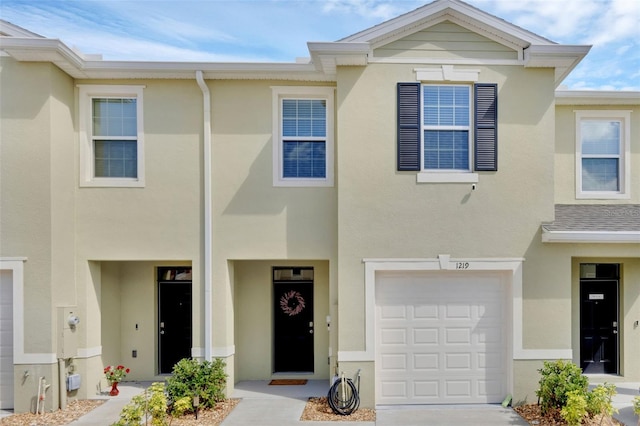 1219 Lido Dr, Howey In The Hills, FL 34737 - townhome / multi-family property featuring an attached garage, stucco siding, and concrete driveway